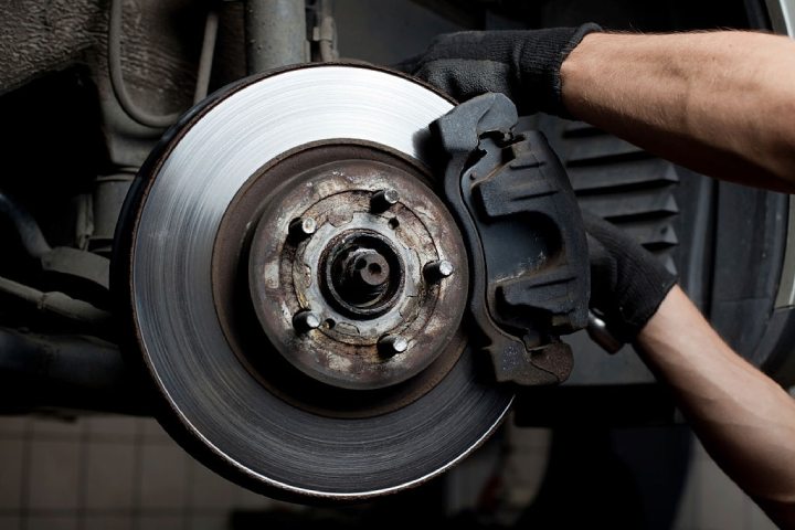 mechanic working on brake lines