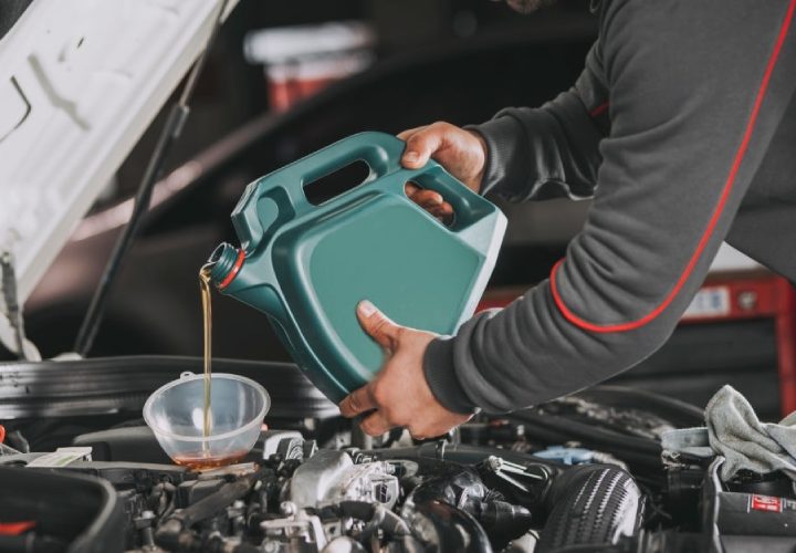 mechanic performing oil change