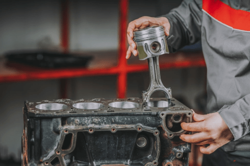 mechanic repairs engine piston