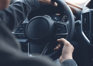 man turning steering wheel