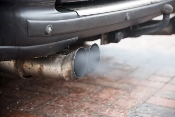 car without muffler creating toxic fumes